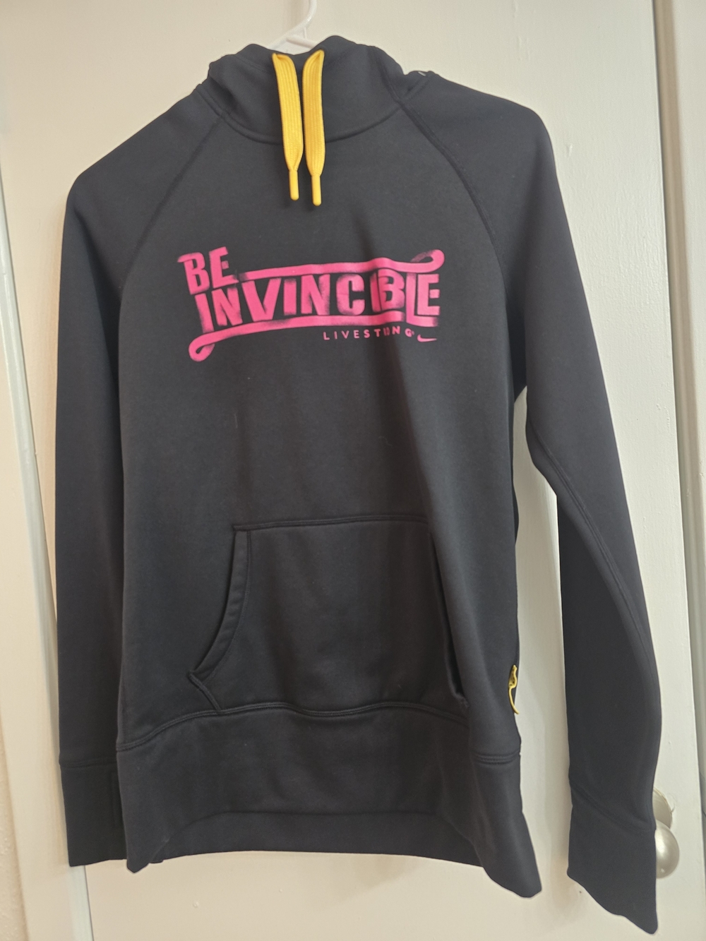 Nike Black Hoodie with Pink "Be Invincible" Logo and Yellow Drawstrings